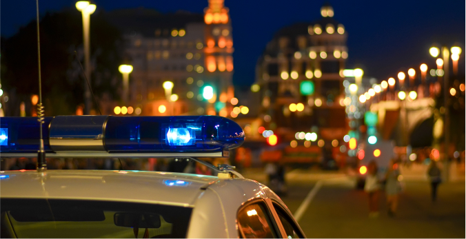 Top of a police car with a blurry city in the background